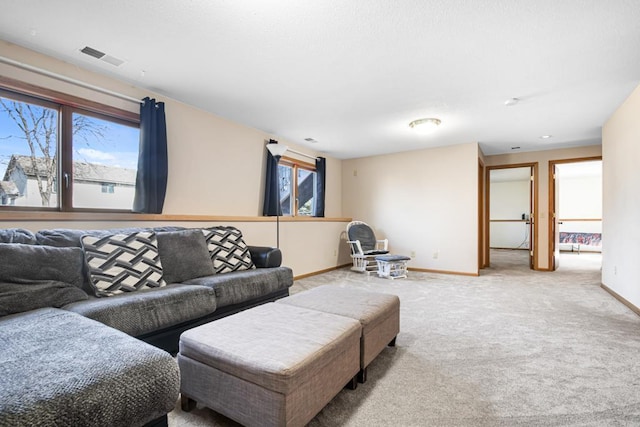 carpeted living area featuring visible vents, a healthy amount of sunlight, and baseboards