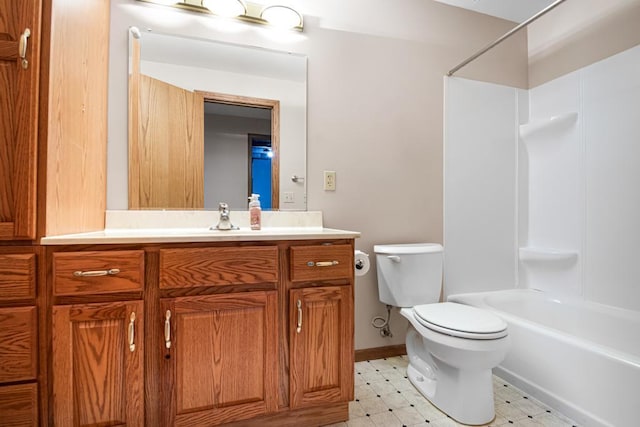 bathroom with vanity, washtub / shower combination, baseboards, tile patterned floors, and toilet