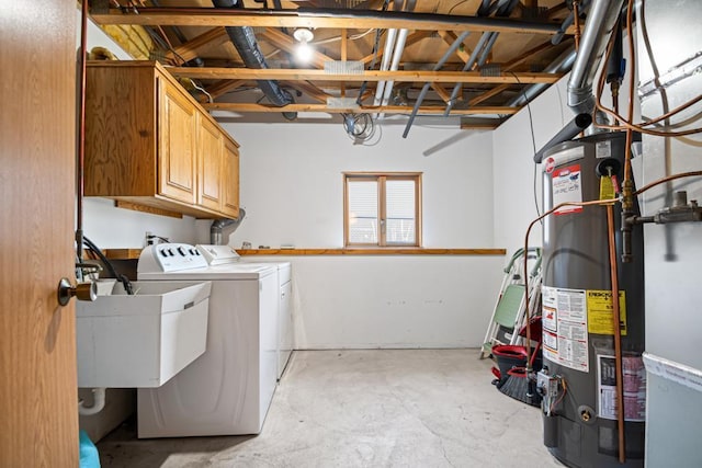 washroom featuring a sink, cabinet space, gas water heater, and separate washer and dryer