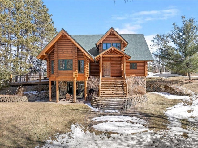 log home featuring stairs, log exterior, a patio area, and stone siding