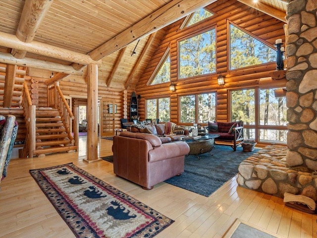 living area featuring beam ceiling, high vaulted ceiling, and hardwood / wood-style flooring