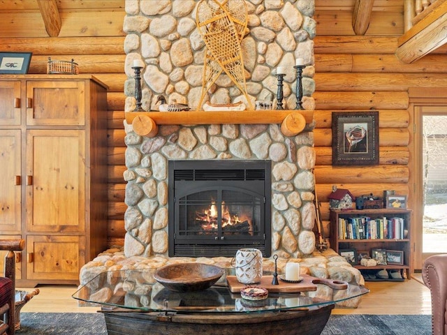 details featuring a fireplace, log walls, and wood finished floors