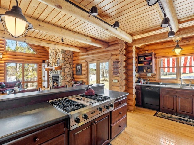 kitchen with stainless steel gas cooktop, beamed ceiling, light wood-type flooring, black dishwasher, and rustic walls