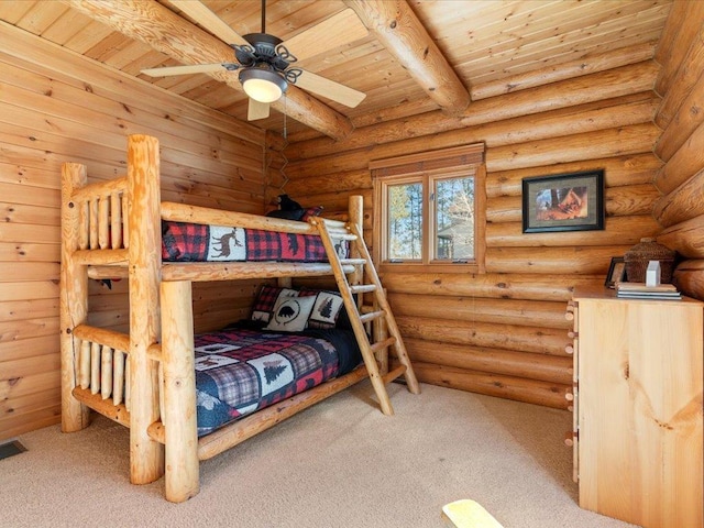 carpeted bedroom with beam ceiling, visible vents, wood ceiling, and log walls