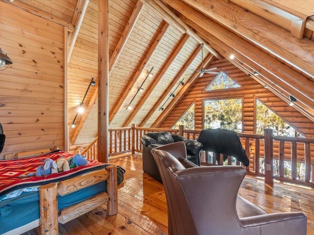 interior space with wooden ceiling, vaulted ceiling with beams, wood-type flooring, and rustic walls