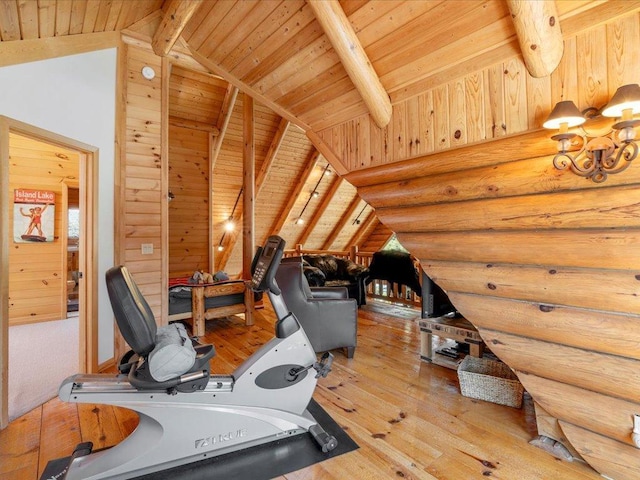 workout room featuring rustic walls, lofted ceiling, wood ceiling, and hardwood / wood-style flooring