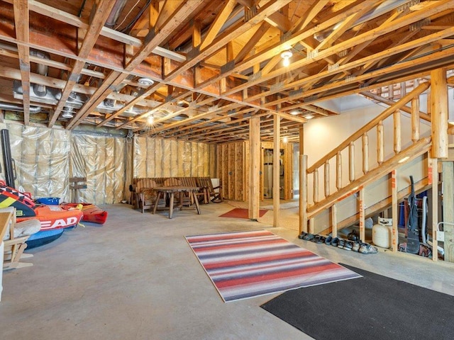 unfinished basement featuring stairway