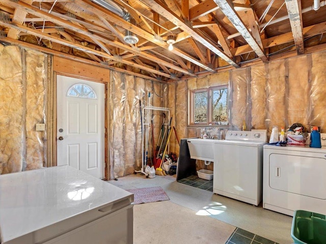 below grade area featuring separate washer and dryer and a sink