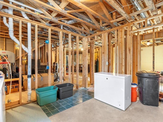 unfinished basement featuring fridge