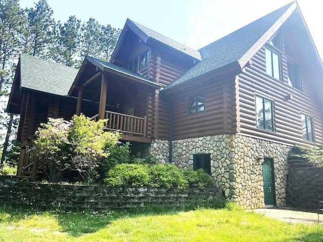 11766 Island Shore Ln, Park Rapids, MN 56470 - view of home's exterior featuring log exterior, stone siding, roof with shingles, and a balcony