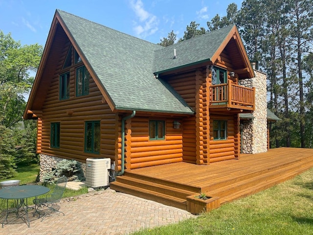 11766 Island Shore Ln, Park Rapids, MN 56470 - rear view of house featuring a balcony, roof with shingles, cooling unit, and log siding