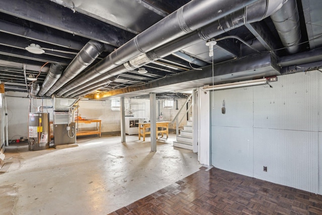 basement with heating unit, gas water heater, washer / clothes dryer, and stairs