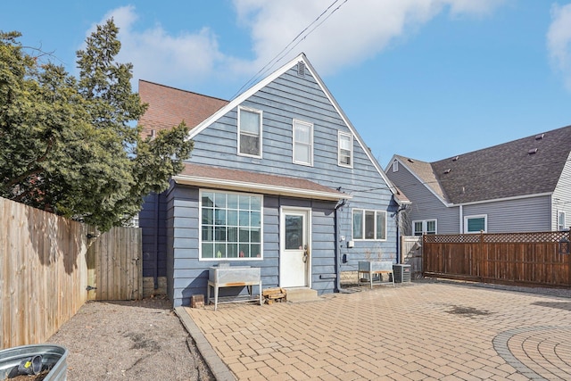 back of property featuring a patio area, central AC unit, entry steps, and a fenced backyard