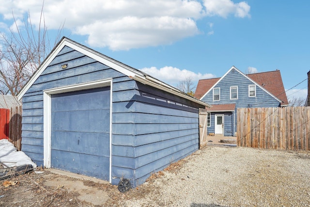 detached garage featuring fence