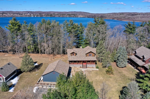 birds eye view of property featuring a view of trees and a water view