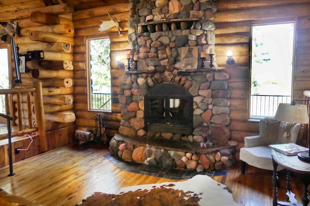 living area featuring log walls and hardwood / wood-style floors