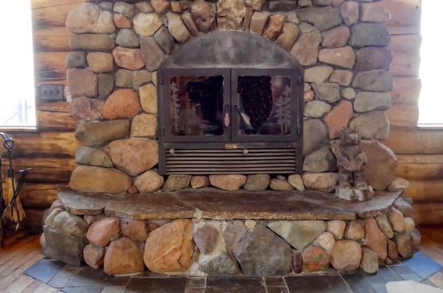 room details with a wood stove and wood finished floors