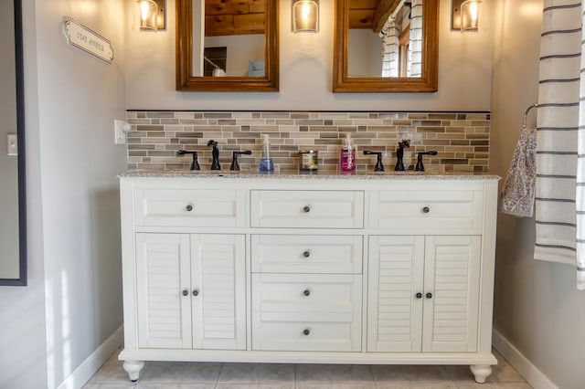 bar featuring baseboards, backsplash, and a sink