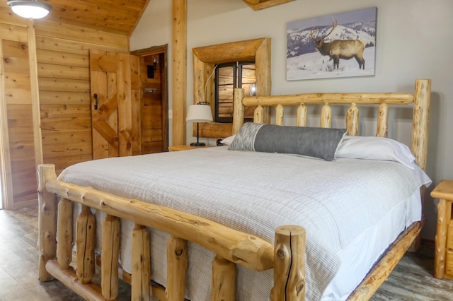 bedroom featuring lofted ceiling, wood finished floors, and wooden ceiling