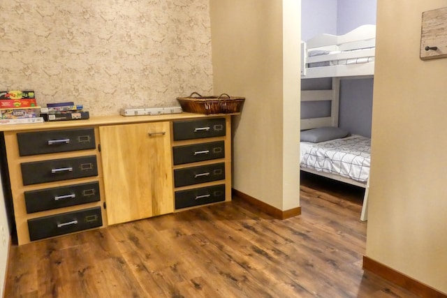 interior space with dark wood-type flooring and baseboards