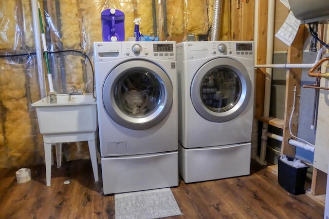 laundry room featuring wood finished floors, laundry area, and washing machine and clothes dryer