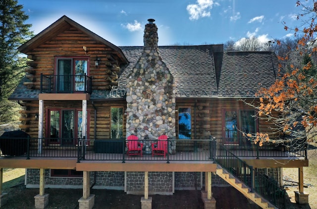 871 207th St, Dresser, WI 54009 - rear view of property featuring log siding, a balcony, stairway, and a chimney