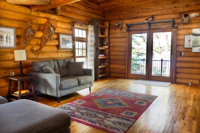 871 207th St, Dresser, WI 54009 - living room featuring hardwood / wood-style floors, lofted ceiling, and log walls