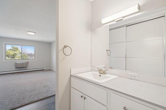 bathroom with vanity and baseboard heating