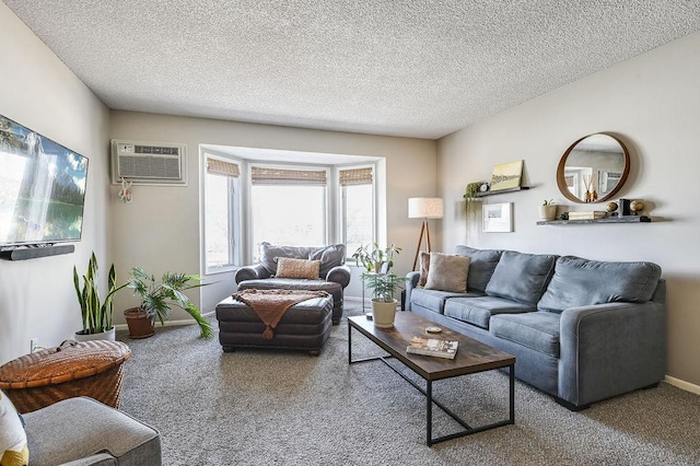 carpeted living area with baseboards, a textured ceiling, and a wall unit AC