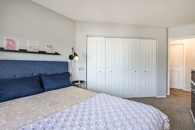 carpeted bedroom featuring a textured ceiling and a closet