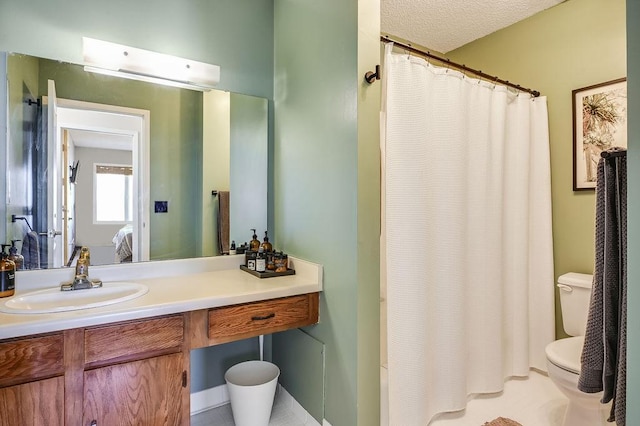 ensuite bathroom featuring ensuite bathroom, vanity, and toilet