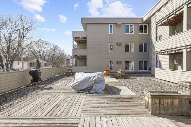 deck featuring fence and a wall mounted air conditioner