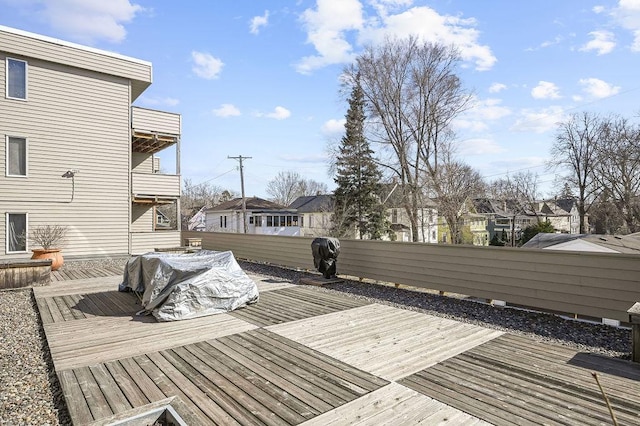 wooden deck with fence and a residential view