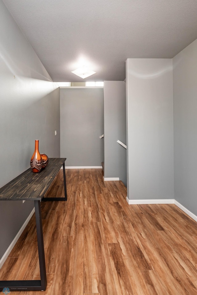 finished basement featuring baseboards and wood finished floors