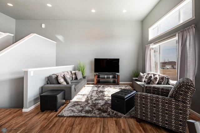 living room featuring recessed lighting, baseboards, and wood finished floors