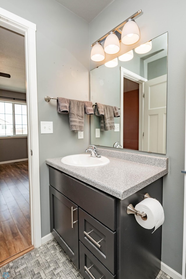 bathroom featuring baseboards and vanity