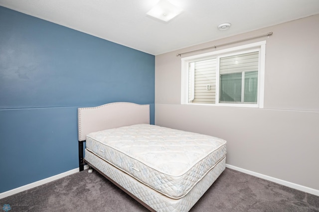 carpeted bedroom featuring baseboards