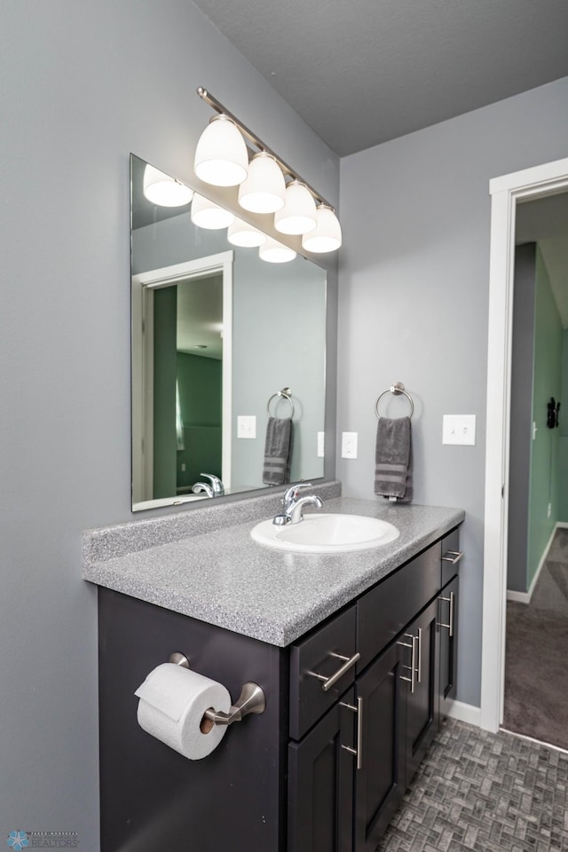 bathroom with vanity and baseboards