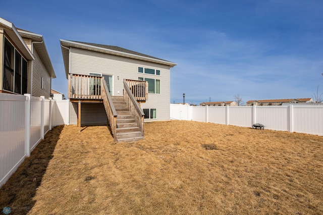 back of house with stairway, a deck, and a fenced backyard