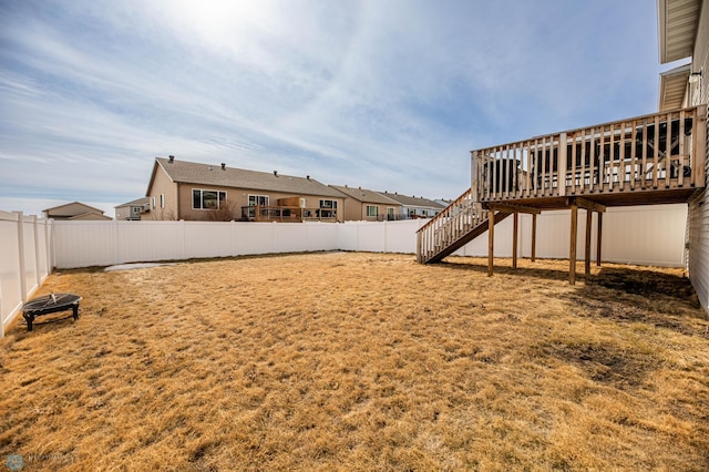 view of yard with stairs, a fenced backyard, and a wooden deck