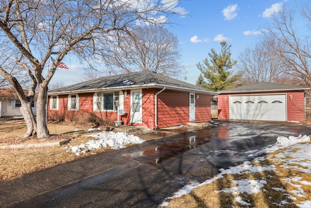 ranch-style house featuring a detached garage and an outbuilding