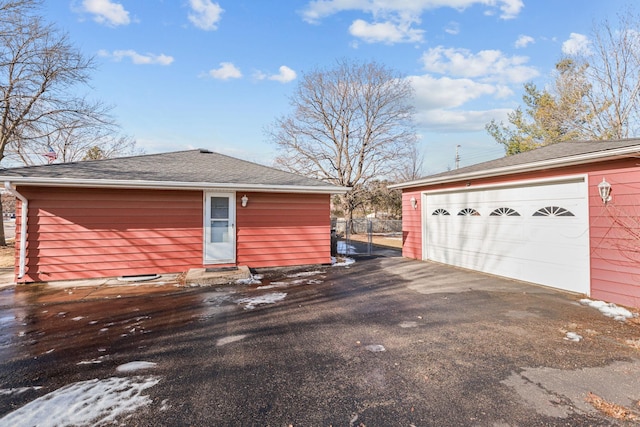 detached garage featuring fence