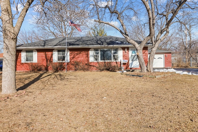 ranch-style house featuring a front yard and a garage