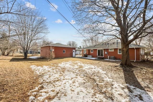 rear view of house with central AC and fence