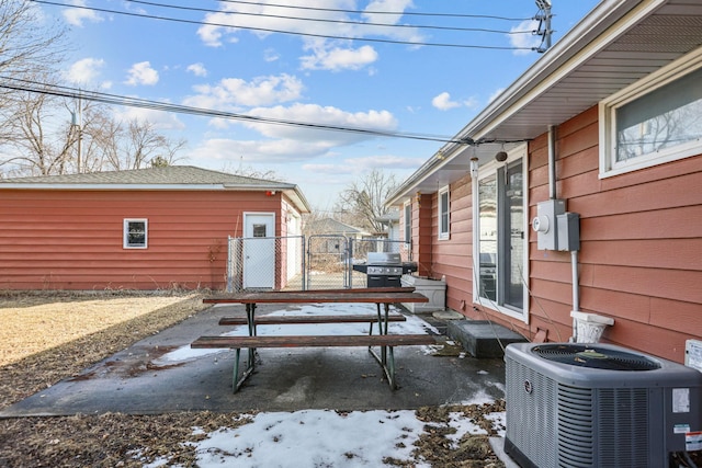 view of patio featuring area for grilling, central air condition unit, a gate, and fence