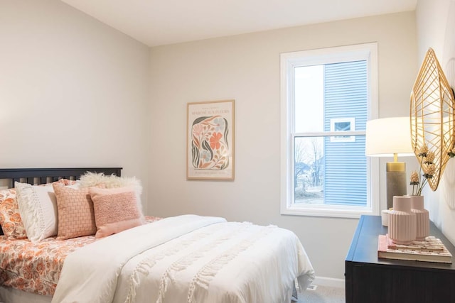 carpeted bedroom featuring baseboards