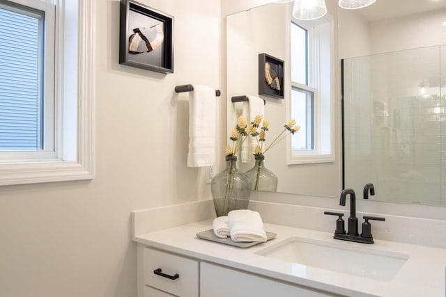 bathroom with vanity and tiled shower