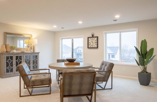 dining area with recessed lighting, baseboards, and light carpet