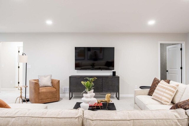 carpeted living room featuring recessed lighting, visible vents, and baseboards