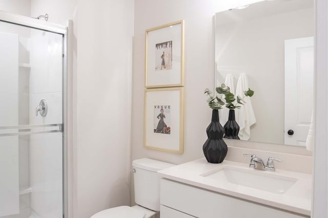 full bath with a shower stall, vanity, and toilet